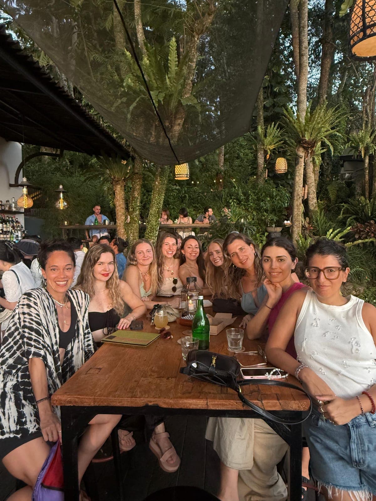 Friends gathered around a long table for dinner